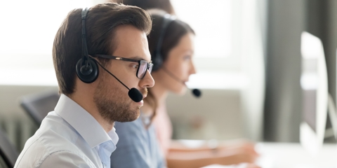 Confident call center operator agent in headset consulting client online