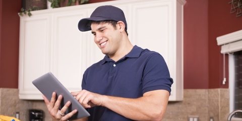 Repairman working inside customer's home with iPad.
