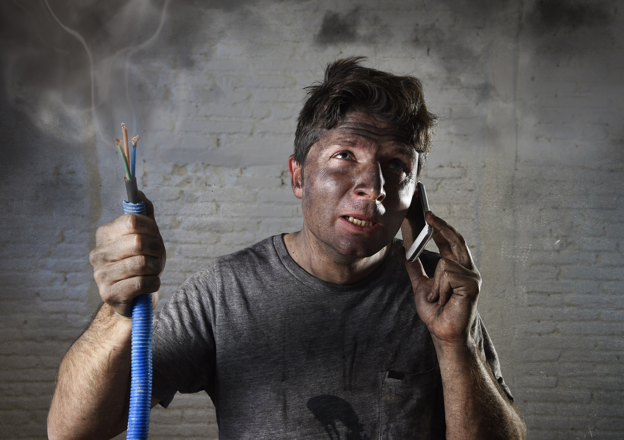Electrocuted man calling for help in dirty burnt funny face